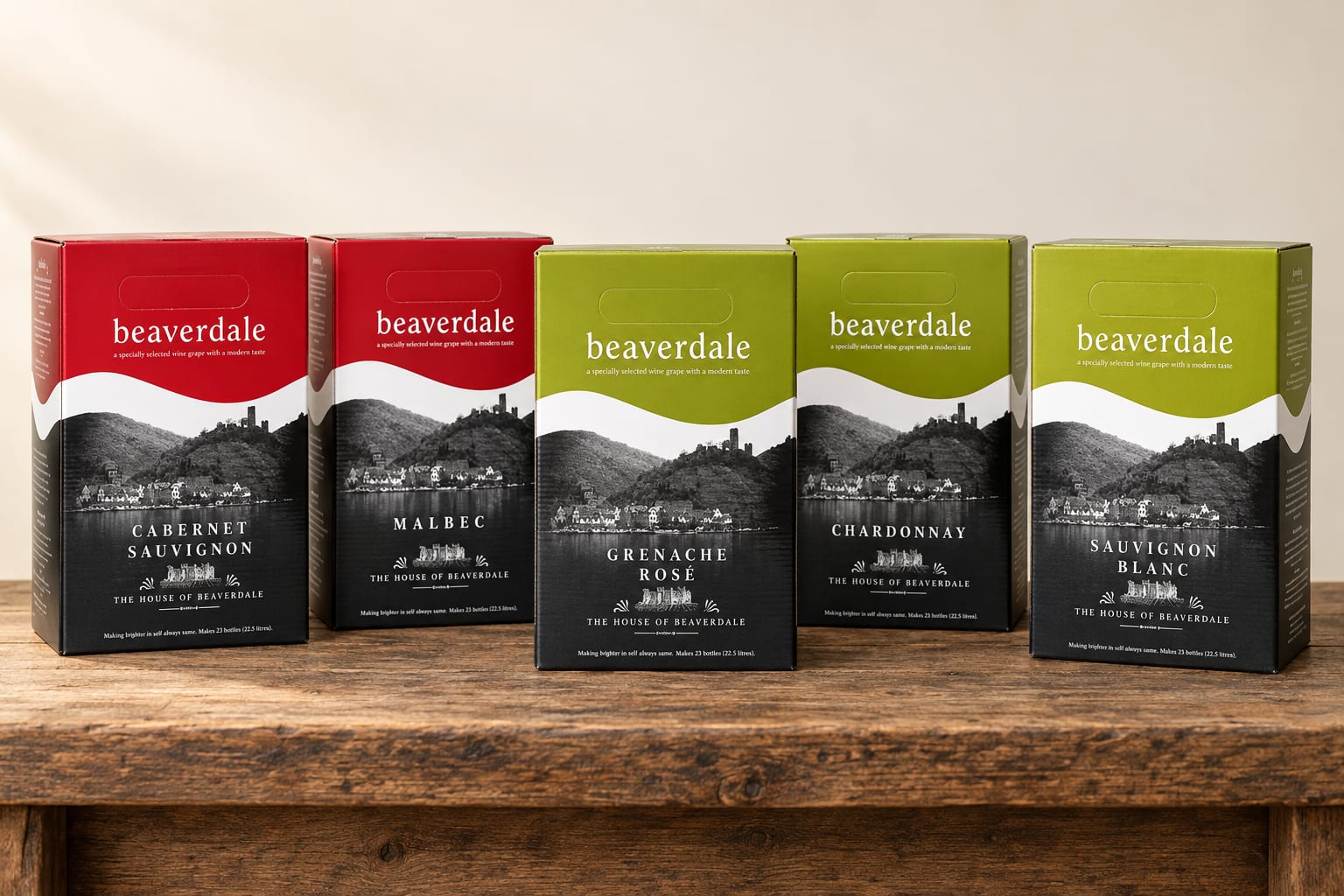Five Beaverdale wine kit boxes standing on a wooden bench: Cabernet Sauvignon, Malbec, Grenache Rosé, Chardonnay and Sauvignon Blanc, each with a coloured top panel over a black-and-white riverside photograph.